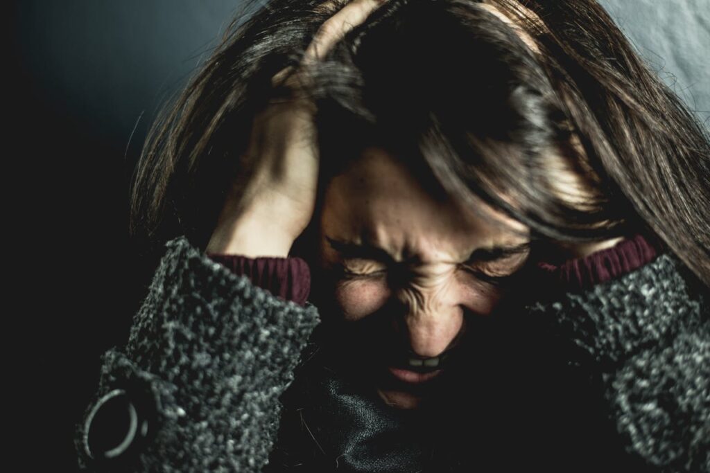 Photo by David Garrison: https://www.pexels.com/photo/woman-holding-her-head-2128817/